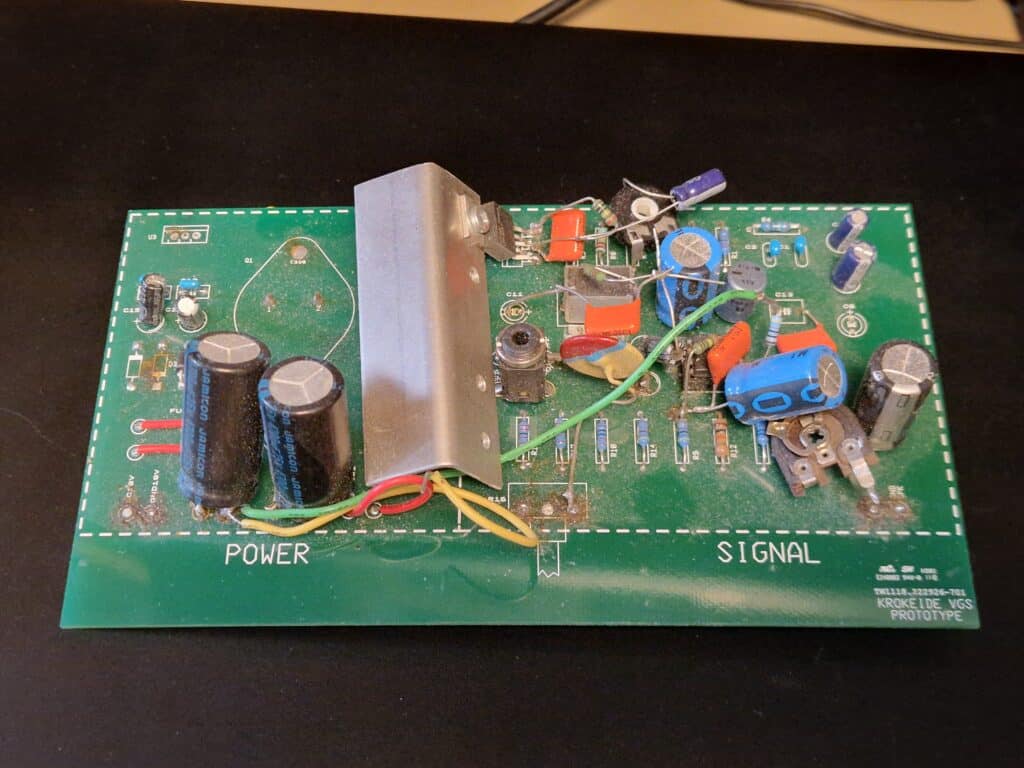 02 - prototype 2 Et grønt kretskort merket «POWER» og «SIGNAL» med ulike elektroniske komponenter, blant annet kondensatorer, motstander og en kjøleribbe, koblet sammen med ledninger.